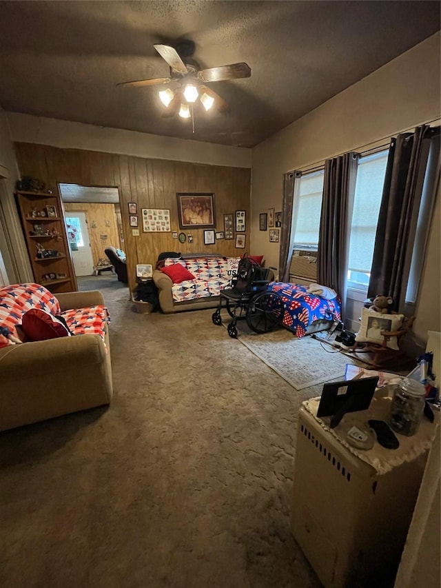 408 N Woods St, Sherman, TX 75092 - carpeted bedroom featuring wood walls, a ceiling fan, and a textured ceiling