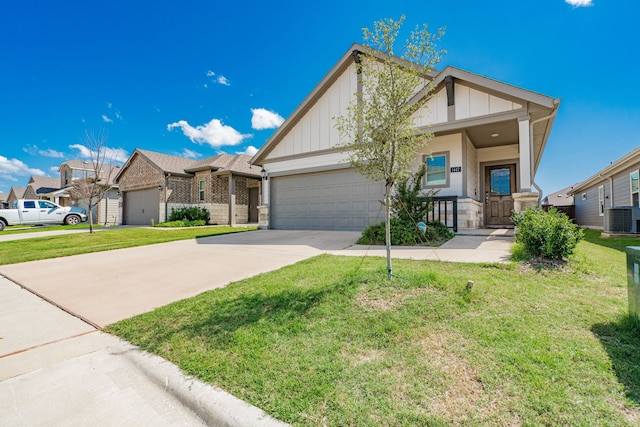 1447 Rolling Fox Dr, Forney, TX 75126 - view of front of property featuring board and batten siding, a garage, driveway, and a front yard