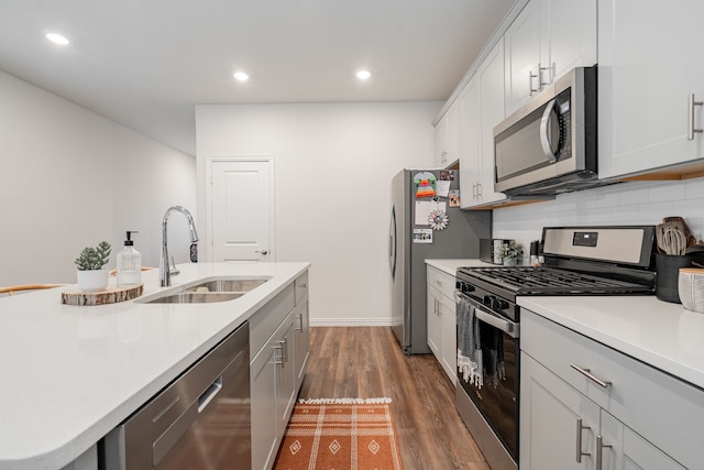 1447 Rolling Fox Dr, Forney, TX 75126 - kitchen featuring stainless steel appliances, wood finished floors, light countertops, recessed lighting, and a kitchen island with sink