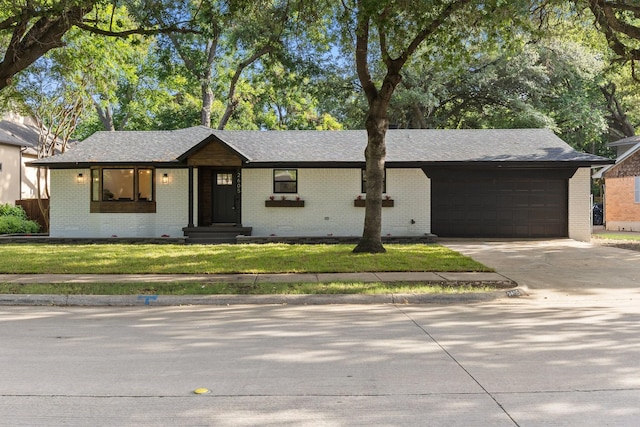 2605 S Glenbrook Dr, Garland, TX 75041 - ranch-style house with brick siding, an attached garage, and driveway