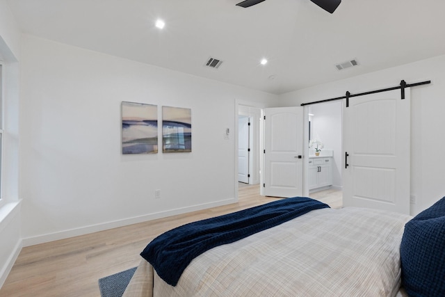 2605 S Glenbrook Dr, Garland, TX 75041 - bedroom with light wood-style floors, a barn door, recessed lighting, ensuite bath, and a ceiling fan