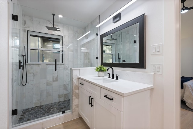2605 S Glenbrook Dr, Garland, TX 75041 - bathroom with a shower stall, vanity, and wood finished floors