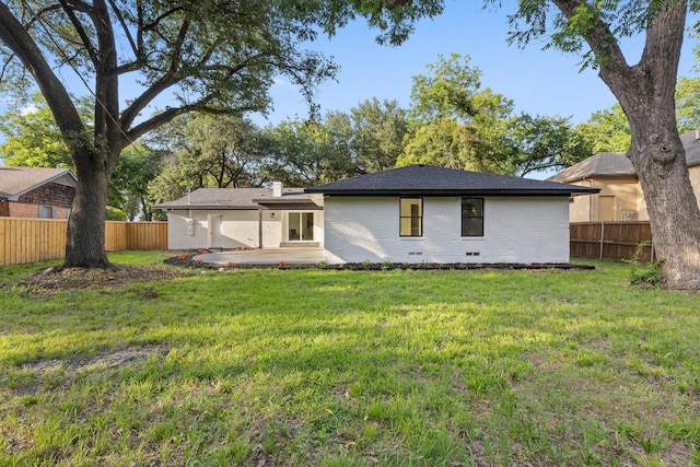 2605 S Glenbrook Dr, Garland, TX 75041 - back of house featuring brick siding, a patio area, and a chimney