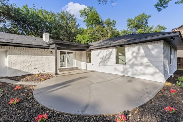 2605 S Glenbrook Dr, Garland, TX 75041 - rear view of house with brick siding, a patio area, and a chimney