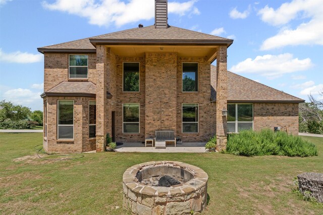 111 Meadow Bridge Dr, Weatherford, TX 76085 - back of property with brick siding, a fire pit, a patio area, and a lawn