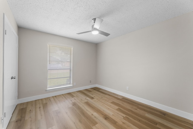 1124 Janell Dr, Irving, TX 75062 - spare room featuring light wood-style floors, a textured ceiling, and a ceiling fan