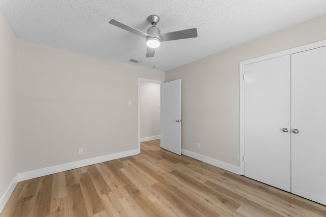 1124 Janell Dr, Irving, TX 75062 - unfurnished bedroom with light wood finished floors, a textured ceiling, a closet, and ceiling fan