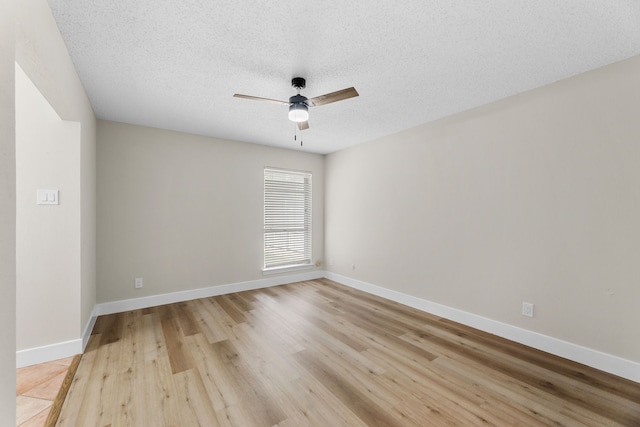 1124 Janell Dr, Irving, TX 75062 - spare room featuring a ceiling fan, light wood-type flooring, and a textured ceiling