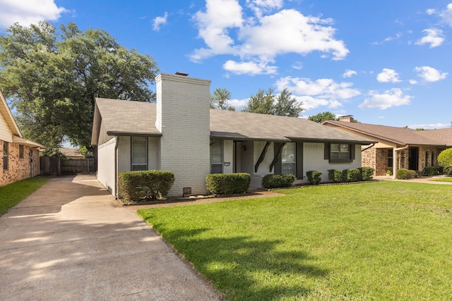 1124 Janell Dr, Irving, TX 75062 - view of front of house featuring driveway, a chimney, and brick siding