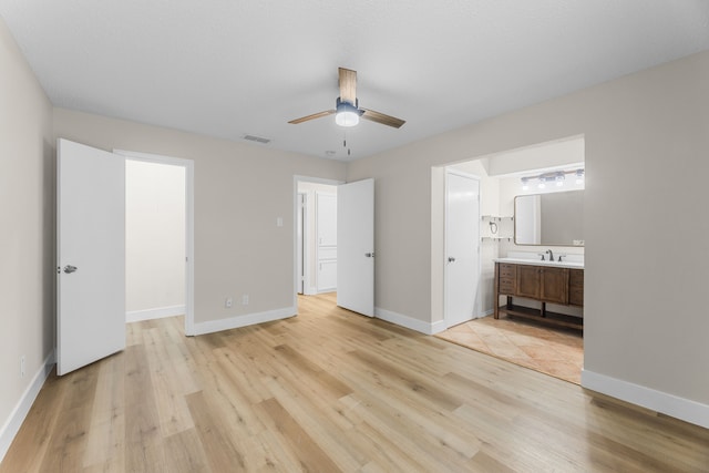 1124 Janell Dr, Irving, TX 75062 - unfurnished bedroom with light wood-style flooring, connected bathroom, and a ceiling fan