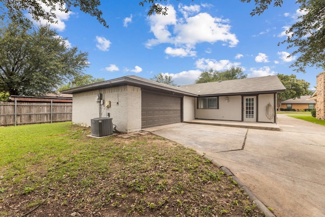 1124 Janell Dr, Irving, TX 75062 - rear view of property featuring concrete driveway, a garage, and brick siding