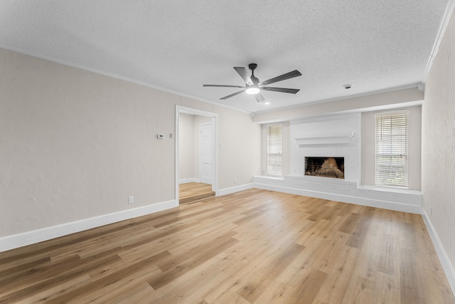 1124 Janell Dr, Irving, TX 75062 - unfurnished living room with a textured ceiling, healthy amount of natural light, ceiling fan, light wood-style floors, and crown molding