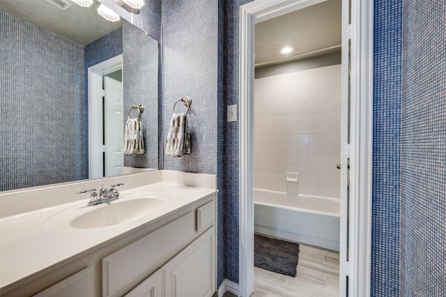 5914 Brookhill Ln, Frisco, TX 75034 - full bath featuring vanity, wood finished floors, shower / tub combo, and wallpapered walls