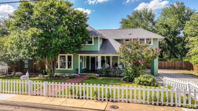 305 E Lee Ave, Weatherford, TX 76086 - view of front of house featuring a porch, roof with shingles, and a fenced front yard