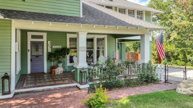305 E Lee Ave, Weatherford, TX 76086 - view of exterior entry featuring a porch, roof with shingles, and a gate