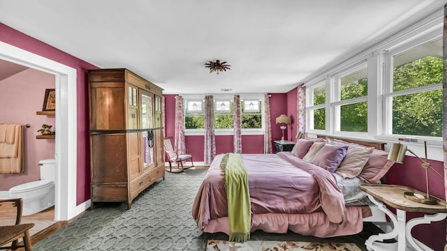 305 E Lee Ave, Weatherford, TX 76086 - bedroom with ensuite bath and carpet floors