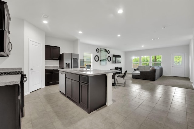 16721 Porterfield Ln, Justin, TX 76247 - kitchen with stainless steel appliances, open floor plan, a kitchen island with sink, light countertops, and recessed lighting