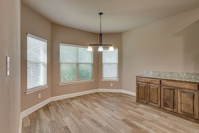924 Via Barcelona, Mesquite, TX 75150 - unfurnished dining area with light wood-type flooring and healthy amount of natural light