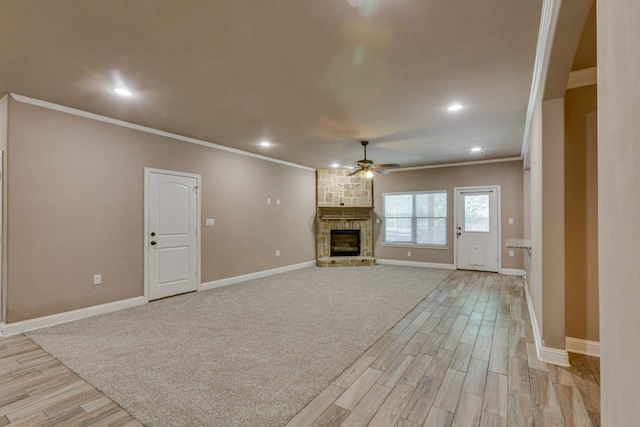 924 Via Barcelona, Mesquite, TX 75150 - unfurnished living room featuring a ceiling fan, light wood-style flooring, ornamental molding, recessed lighting, and a fireplace