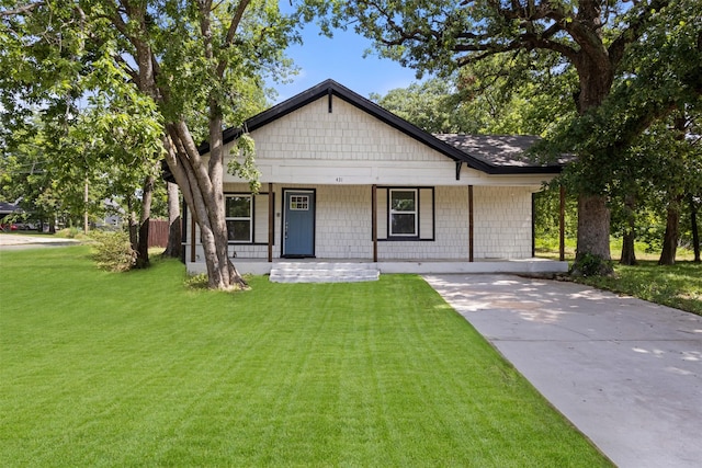 431 W Texas St, Denison, TX 75020 - view of front of house with covered porch, a front lawn, and concrete driveway