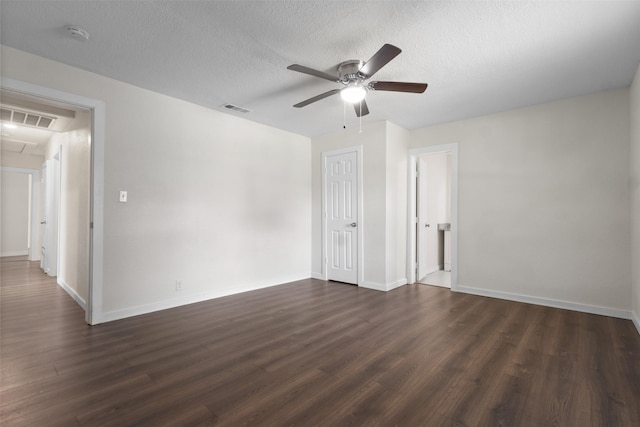 431 W Texas St, Denison, TX 75020 - empty room with ceiling fan, dark wood-style flooring, a smoke detector, attic access, and a textured ceiling