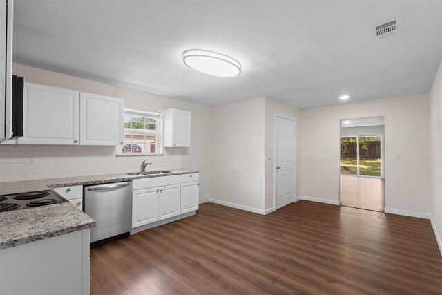 431 W Texas St, Denison, TX 75020 - kitchen with stainless steel dishwasher, dark wood-style flooring, backsplash, healthy amount of natural light, and a textured ceiling