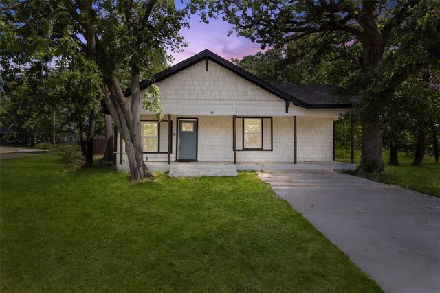 431 W Texas St, Denison, TX 75020 - view of front of house featuring a porch, driveway, and a front yard