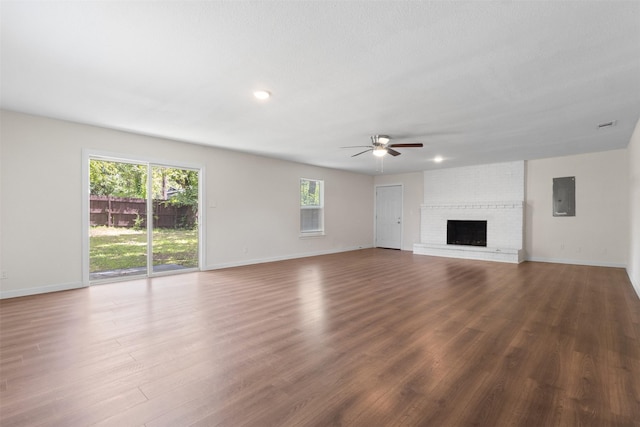 431 W Texas St, Denison, TX 75020 - unfurnished living room with electric panel, a ceiling fan, wood finished floors, a brick fireplace, and recessed lighting