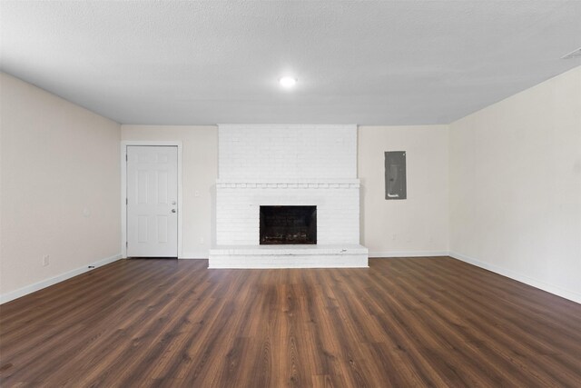 431 W Texas St, Denison, TX 75020 - unfurnished living room with electric panel, wood finished floors, a fireplace, and recessed lighting