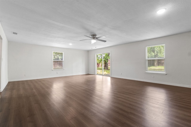 431 W Texas St, Denison, TX 75020 - unfurnished room with ceiling fan, healthy amount of natural light, dark wood-style floors, a textured ceiling, and recessed lighting