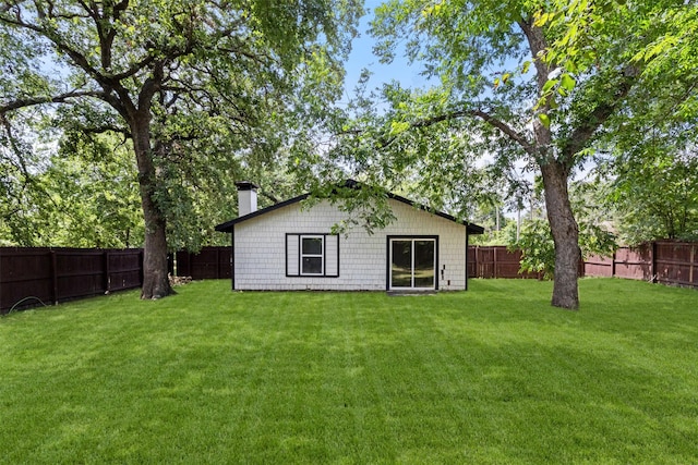 431 W Texas St, Denison, TX 75020 - rear view of house featuring a chimney and a fenced backyard