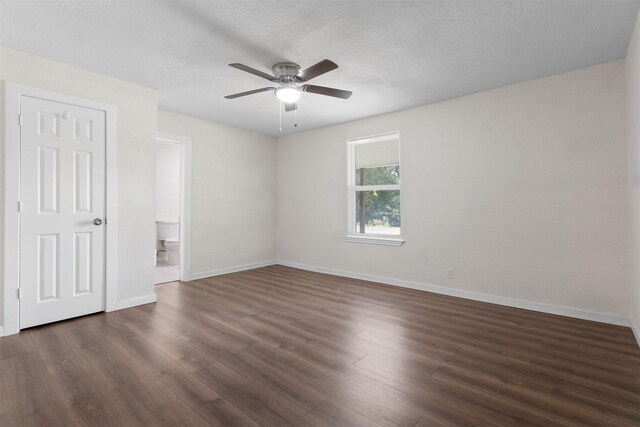 431 W Texas St, Denison, TX 75020 - unfurnished bedroom with dark wood-style flooring, ensuite bathroom, a textured ceiling, and a ceiling fan