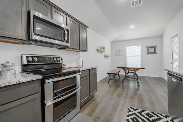 3216 Everly Dr, Fate, TX 75189 - kitchen with stainless steel appliances, tasteful backsplash, dark wood finished floors, light stone countertops, and recessed lighting