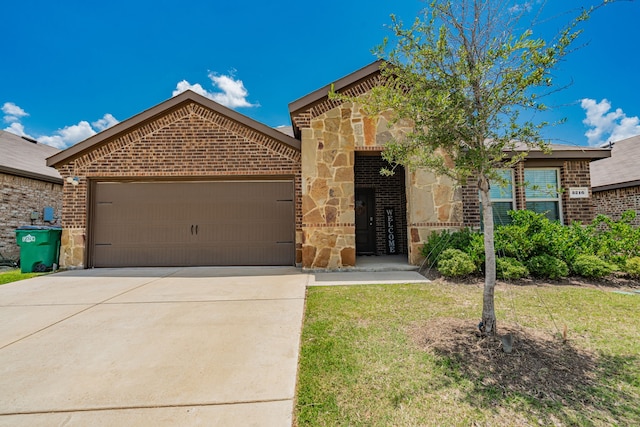 3216 Everly Dr, Fate, TX 75189 - view of front facade featuring brick siding, an attached garage, driveway, stone siding, and a front lawn