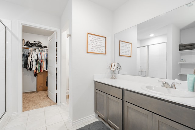 3216 Everly Dr, Fate, TX 75189 - full bath with a walk in closet, a stall shower, vanity, and tile patterned floors