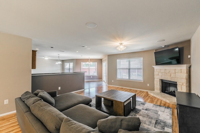 2153 Valley Forge Trl, Fort Worth, TX 76177 - living room with light wood-style floors, a chandelier, and a fireplace