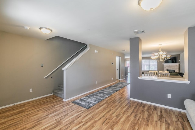 2153 Valley Forge Trl, Fort Worth, TX 76177 - unfurnished living room with wood finished floors, a chandelier, and stairway