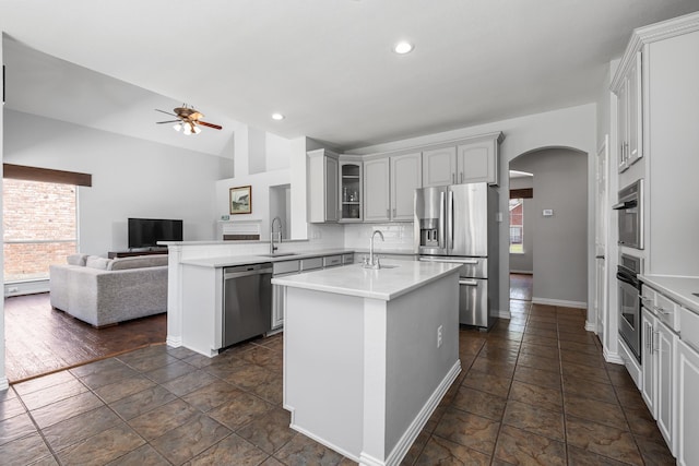 3912 Appleton Ln, Flower Mound, TX 75022 - kitchen featuring stainless steel appliances, plenty of natural light, arched walkways, ceiling fan, and recessed lighting
