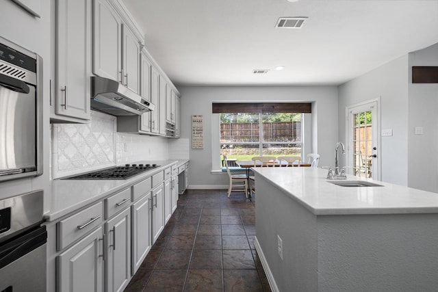 3912 Appleton Ln, Flower Mound, TX 75022 - kitchen with under cabinet range hood, plenty of natural light, backsplash, light countertops, and recessed lighting