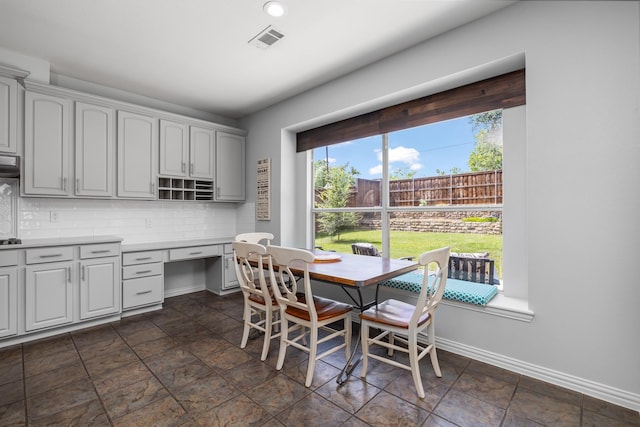 3912 Appleton Ln, Flower Mound, TX 75022 - dining space with built in study area and dark stone finish flooring