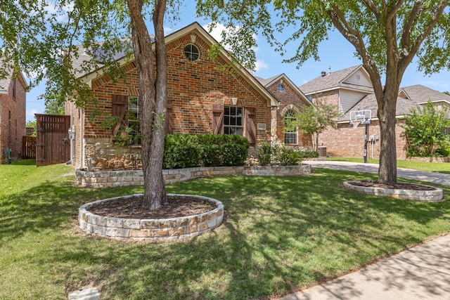 3912 Appleton Ln, Flower Mound, TX 75022 - traditional home with brick siding, a front lawn, and a gate