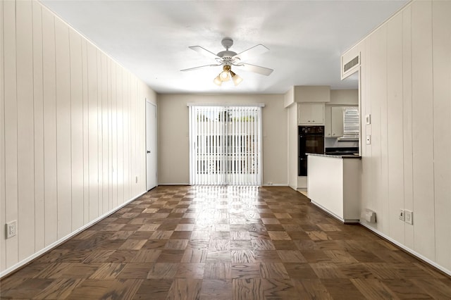 5835 E University Blvd Unit D, Dallas, TX 75206 - unfurnished living room with ceiling fan and wooden walls