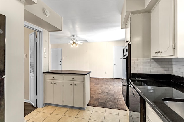 5835 E University Blvd Unit D, Dallas, TX 75206 - kitchen with dark countertops, a ceiling fan, tasteful backsplash, and a peninsula