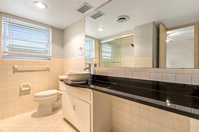 5835 E University Blvd Unit D, Dallas, TX 75206 - full bathroom featuring tile walls, tile patterned floors, vanity, a stall shower, and recessed lighting