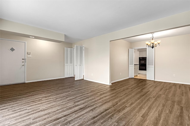5835 E University Blvd Unit D, Dallas, TX 75206 - unfurnished living room featuring wood finished floors and a chandelier