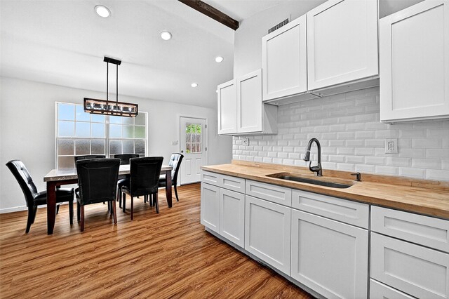 231 Juniper Dr, Pottsboro, TX 75076 - kitchen with wooden counters, backsplash, white cabinetry, recessed lighting, and beamed ceiling