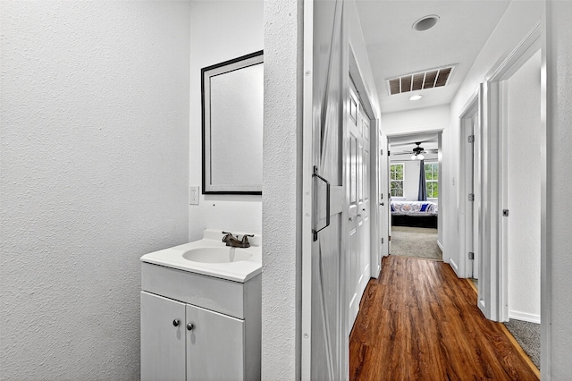 231 Juniper Dr, Pottsboro, TX 75076 - hallway featuring dark wood-style floors, a textured wall, and recessed lighting