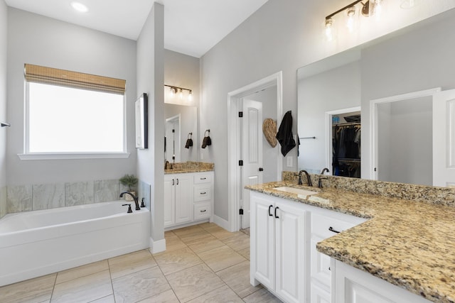 301 Aviara Ct, Poolville, TX 76487 - full bathroom with two vanities, a bath, and a spacious closet