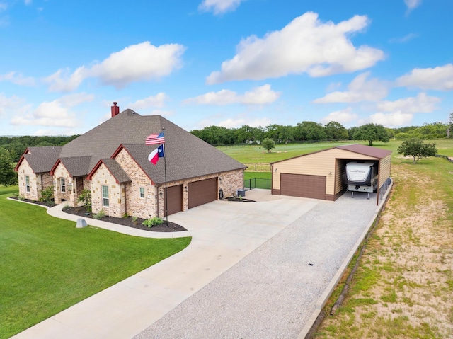 301 Aviara Ct, Poolville, TX 76487 - french country home featuring driveway, a chimney, an outbuilding, stone siding, and a garage