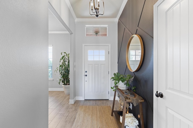 301 Aviara Ct, Poolville, TX 76487 - foyer with healthy amount of natural light, ornamental molding, light wood-style flooring, a chandelier, and a textured wall